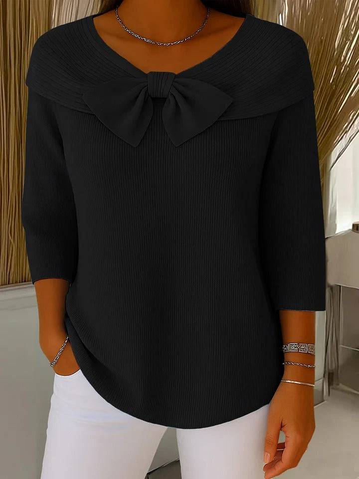 Women's sweater by THE WHITMORE FAMILY featuring a bow detail and round neckline, styled with a cozy knit fabric.