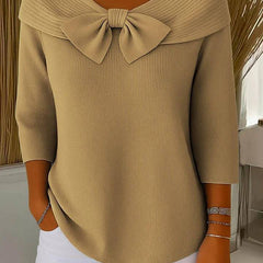 Women's sweater by THE WHITMORE FAMILY featuring a bow detail and round neckline, showcasing the soft knit fabric and stylish design.