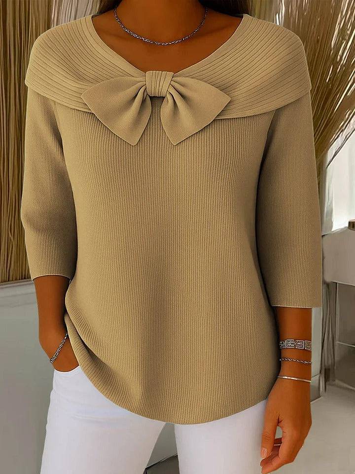 Women's sweater by THE WHITMORE FAMILY featuring a bow detail and round neckline, showcasing the soft knit fabric and stylish design.