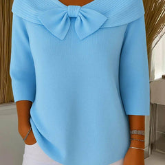 Women’s sweater by THE WHITMORE FAMILY with round neckline and bow detail, featuring a cozy jumper style in soft knit fabric.