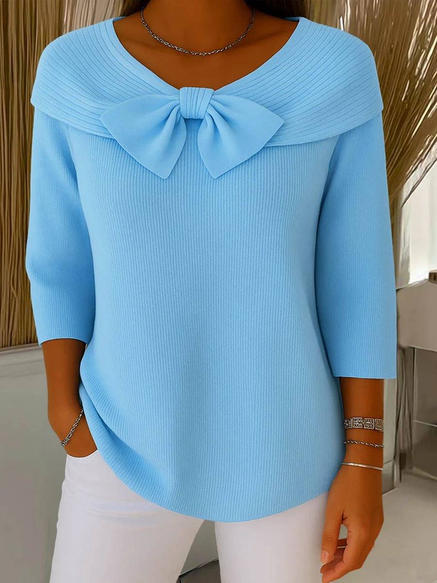 Women’s sweater by THE WHITMORE FAMILY with round neckline and bow detail, featuring a cozy jumper style in soft knit fabric.