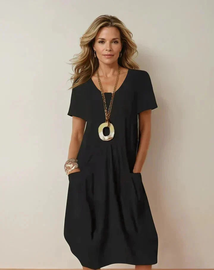 Kwani by THE WHITMORE FAMILY casual flow dress in lightweight fabric, displayed on mannequin with relaxed fit and simple design