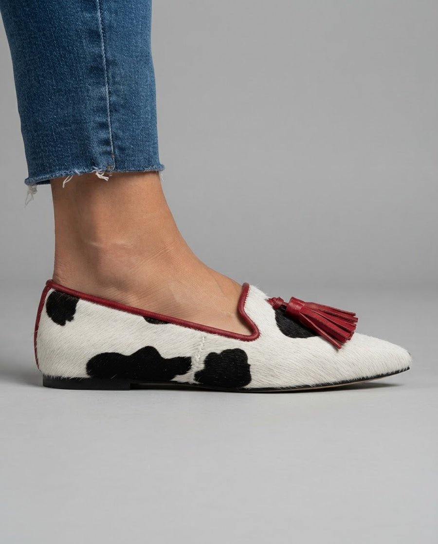 Ginevra Moccasin — Black and White Cow Print, Red Tassels