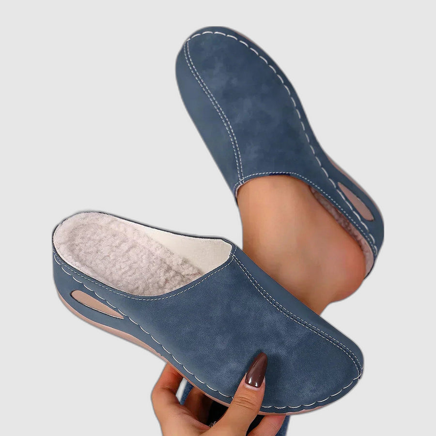 Gray orthopedic slippers from THE WHITMORE FAMILY with cushioned soles and open-back design, ideal for comfort and support.