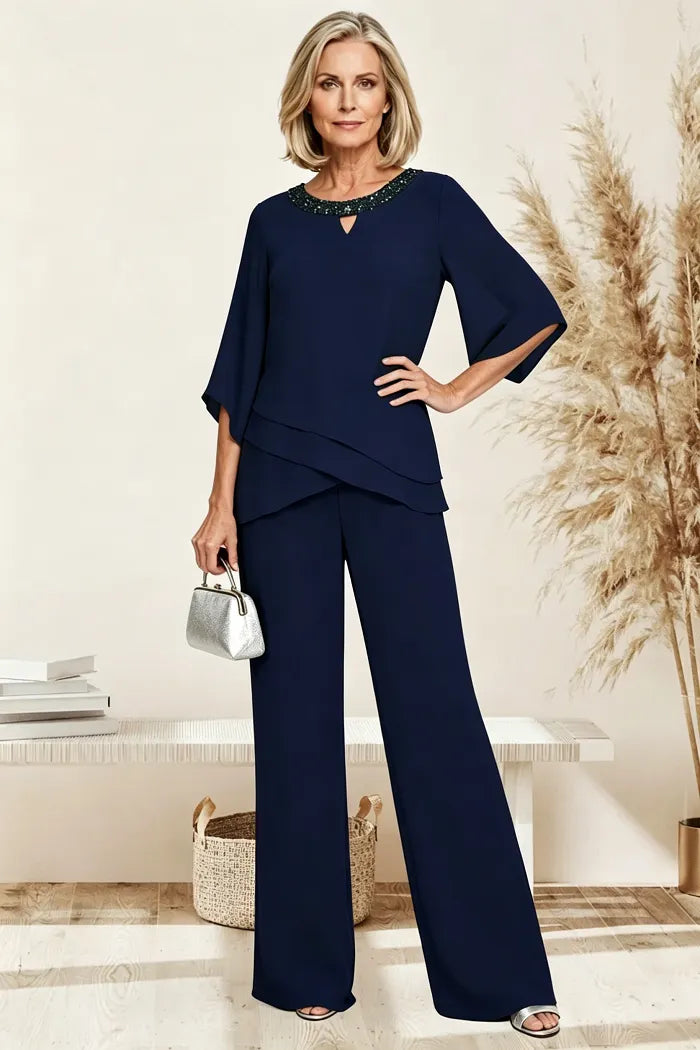 Navy loose-fit formal pant dress set by THE WHITMORE FAMILY, featuring tailored pants and matching top, suitable for a sophisticated occasion.