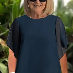 Elegant Beverly™ asymmetrical two-piece set by THE WHITMORE FAMILY, featuring a stylish top and matching skirt in a sophisticated design.