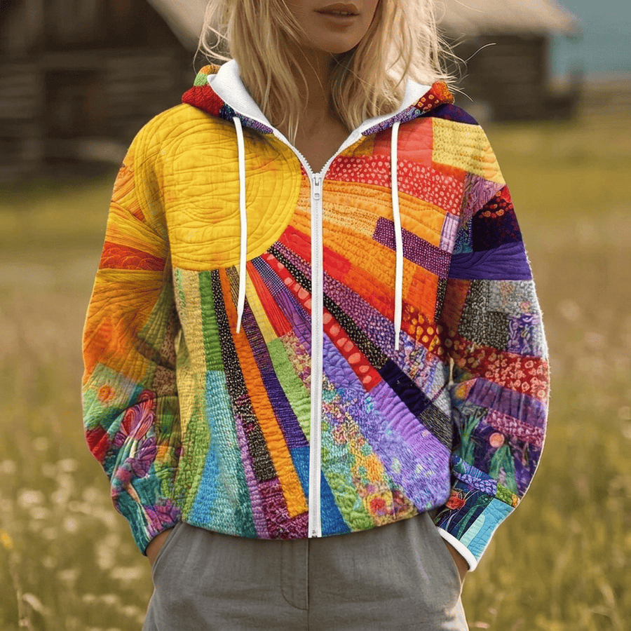 The Mavis Sunburst Zip Jacket by THE WHITMORE FAMILY, a stylish sweater with sunburst design, shown in a close-up view.