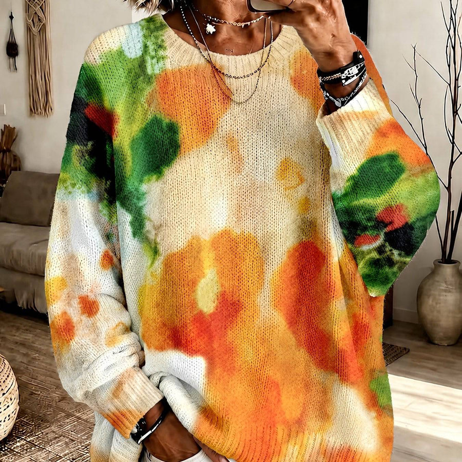 The Ruby tie-dye sweater by THE WHITMORE FAMILY featuring vibrant red and blue patterns, cozy knit fabric, and a classic fit.