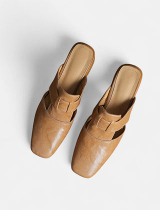 Apricot-colored Andie™ elegant leather sandals by THE WHITMORE FAMILY, featuring stylish straps and a comfortable sole.