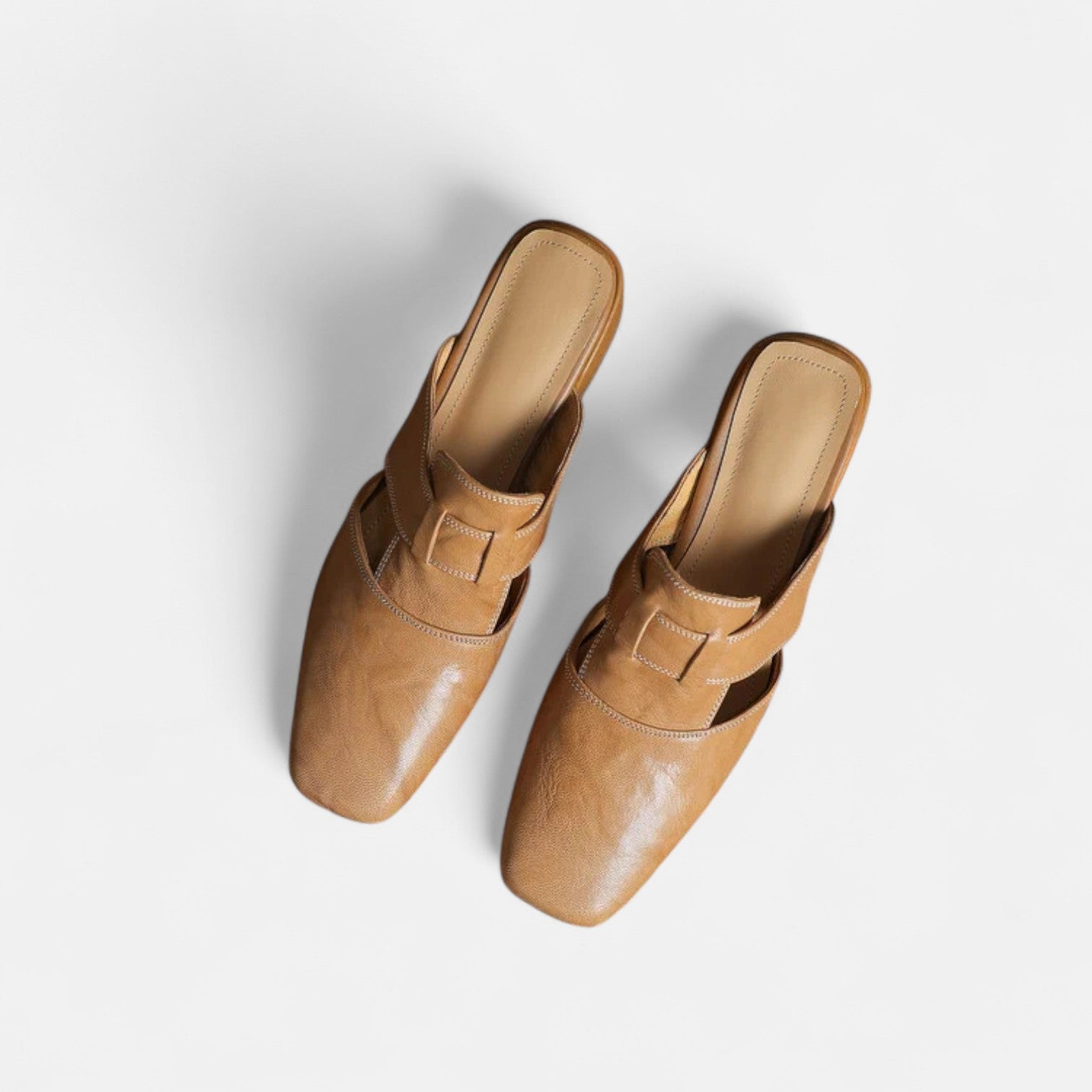 Apricot-colored Andie™ elegant leather sandals by THE WHITMORE FAMILY, featuring stylish straps and a comfortable sole.