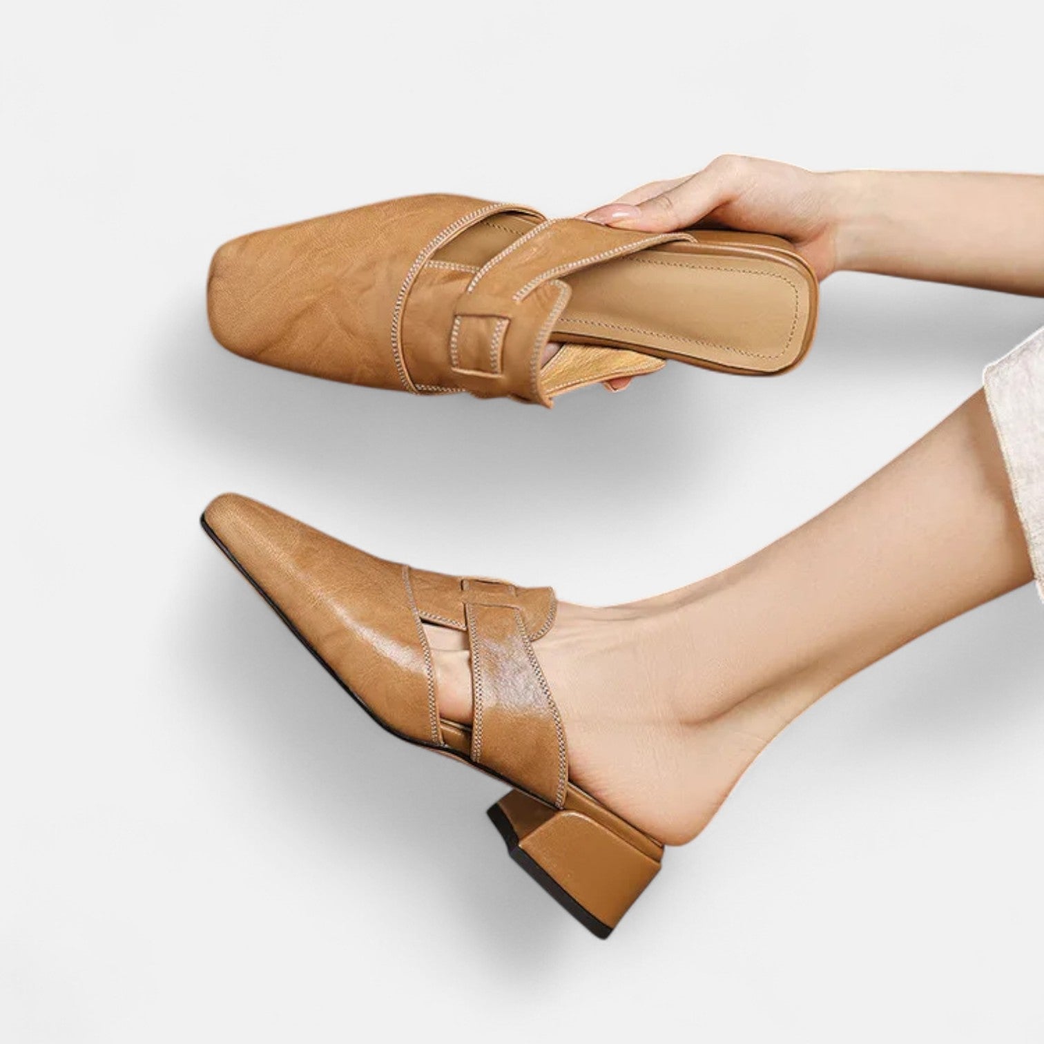 Apricot-colored Andie™ elegant leather sandals by THE WHITMORE FAMILY, showcasing stylish straps and comfortable design.