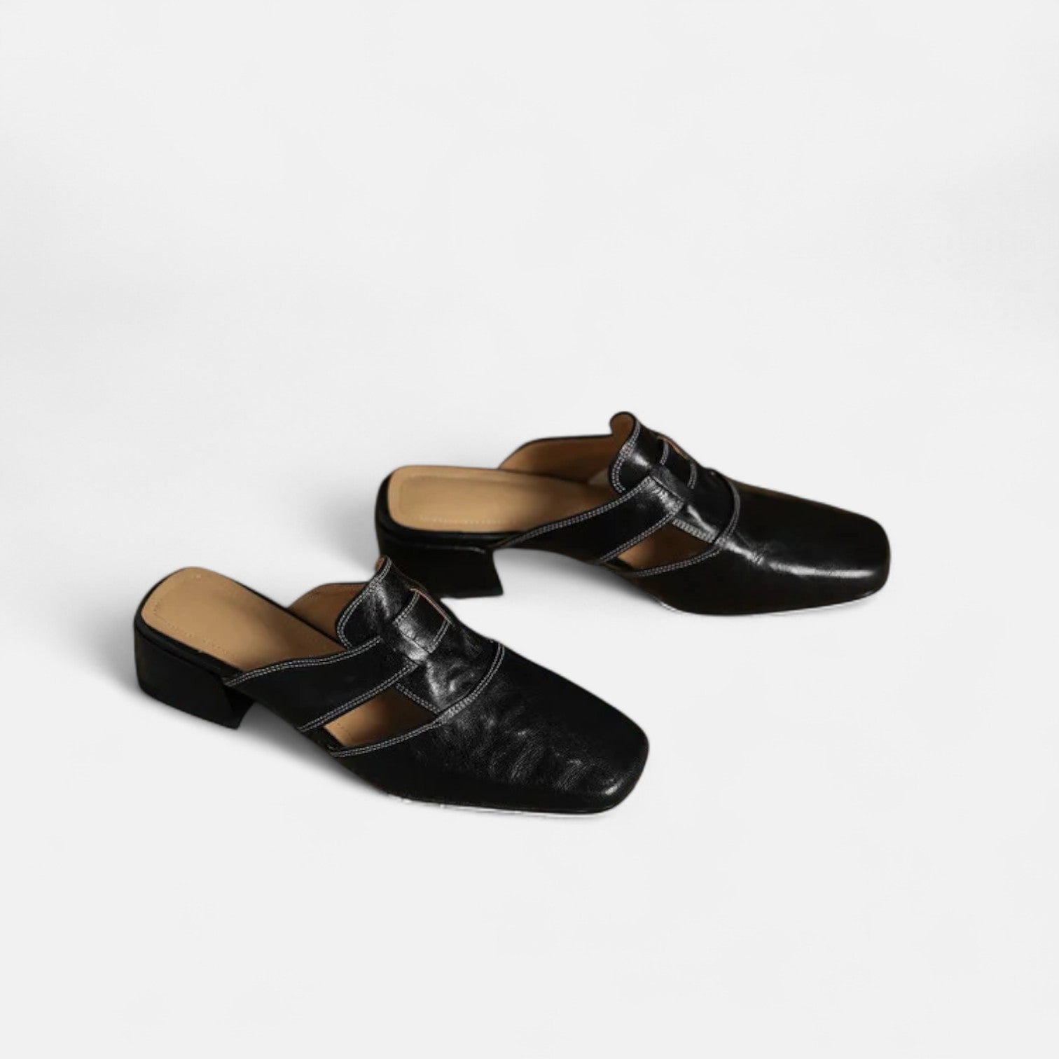 Apricot-colored Andie™ leather sandals by THE WHITMORE FAMILY, featuring elegant straps and a stylish design.
