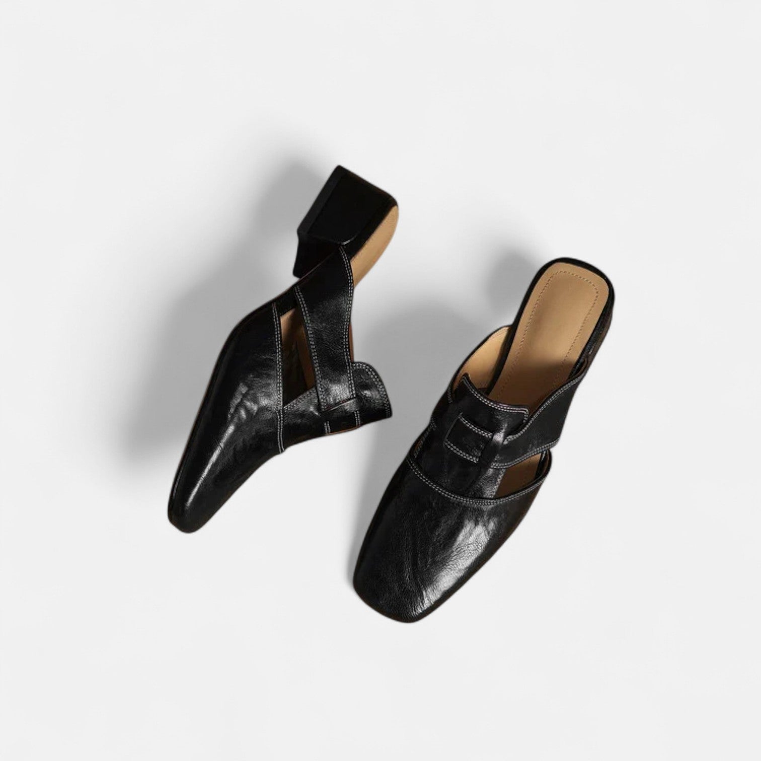 Elegant leather sandals by THE WHITMORE FAMILY featuring apricot-colored straps and a stylish, comfortable design.