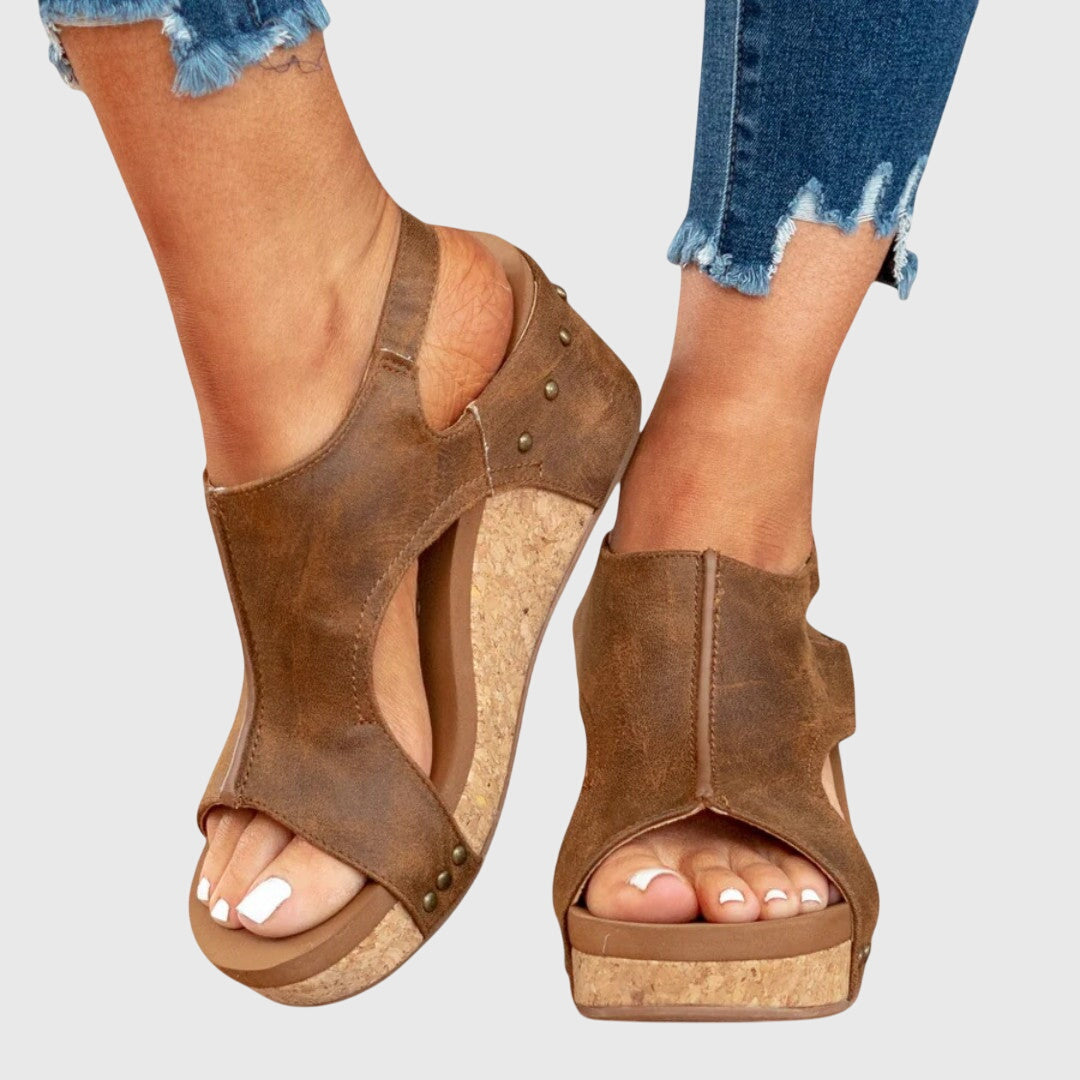 Beige Adela™ orthopedic sandals by THE WHITMORE FAMILY with supportive straps and cushioned soles, designed for comfort and style.