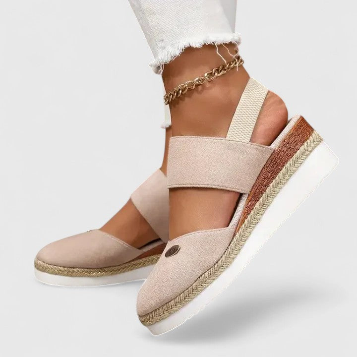 Beige Maylien™ orthopedic sandals by THE WHITMORE FAMILY with supportive straps and cushioned soles for comfort.