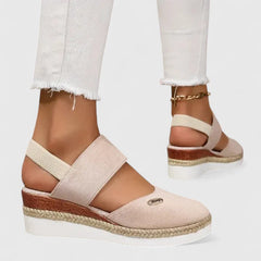 Beige Maylien™ orthopedic sandals from THE WHITMORE FAMILY with adjustable straps and cushioned soles, designed for comfort.