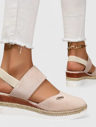 Beige Maylien™ orthopedic sandals from THE WHITMORE FAMILY with adjustable straps and cushioned soles, designed for comfort.
