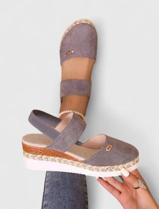 Beige Maylien™ orthopedic sandals by THE WHITMORE FAMILY with supportive straps and cushioned soles, designed for comfort.