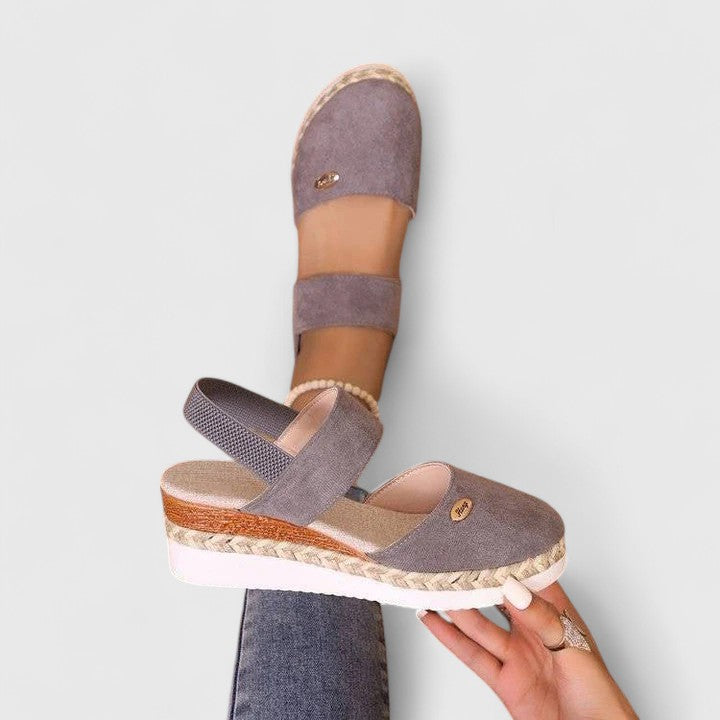 Beige Maylien™ orthopedic sandals by THE WHITMORE FAMILY with supportive straps and cushioned soles, designed for comfort.