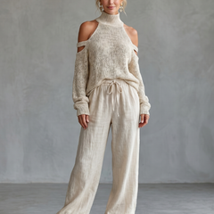 Beige open shoulder knit top and wide-leg pants set by THE WHITMORE FAMILY, featuring a stylish, comfortable knit design.