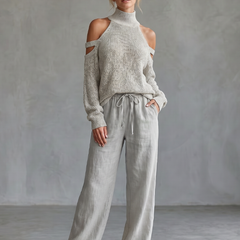 Beige open shoulder knit top and wide-leg pants set by THE WHITMORE FAMILY, stylish casual outfit with relaxed fit.