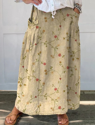 Beige Shane™ retro floral art elastic waistband pocket skirt by THE WHITMORE FAMILY, with a floral pattern and functional pockets.