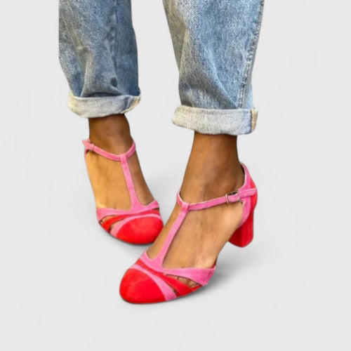 Lazariah modern red heels by THE WHITMORE FAMILY, featuring sleek design and pointed toe, displayed on a white background.