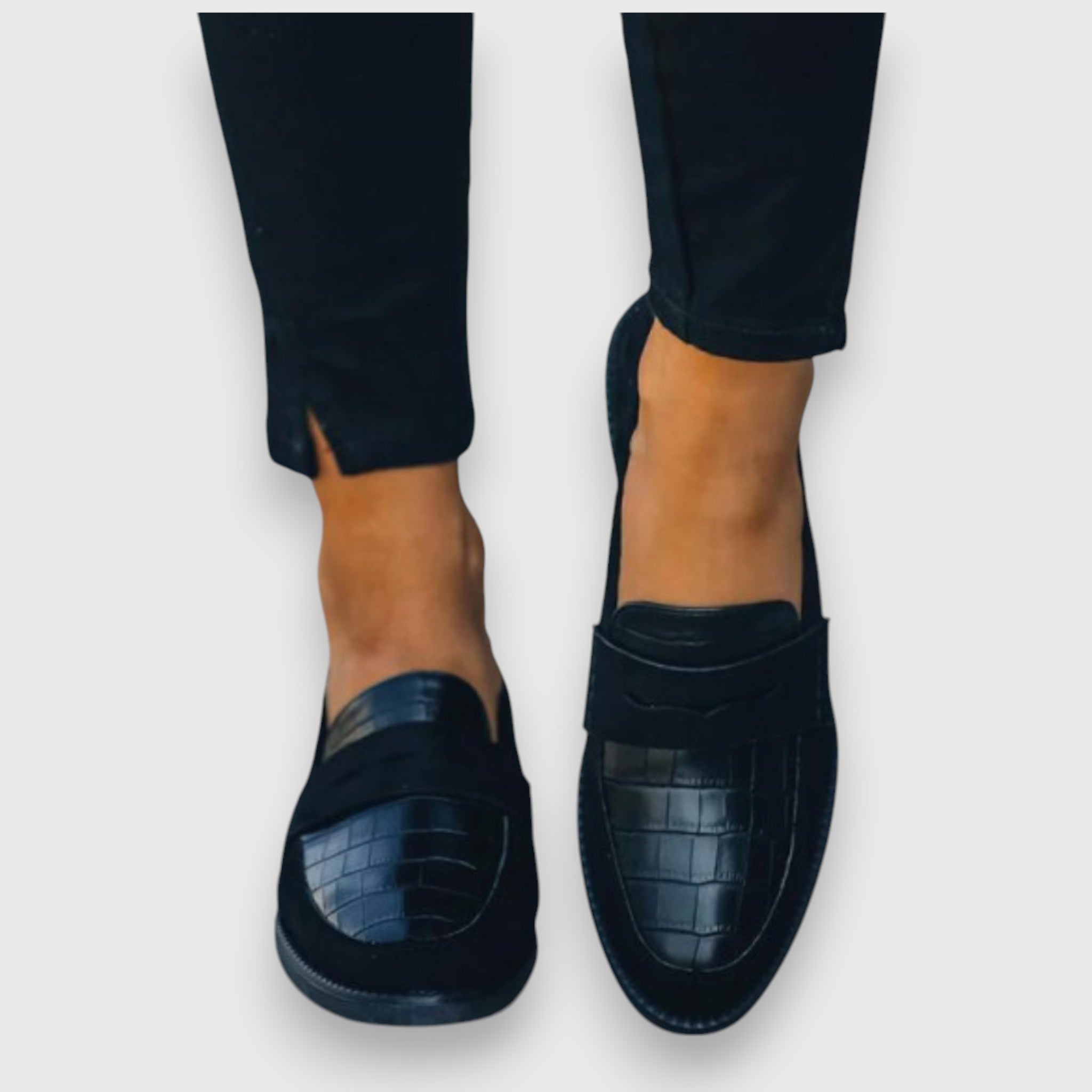 Black Mariluz orthopedic loafers by THE WHITMORE FAMILY, showing stylish slip-on shoes with comfortable design and sturdy soles.
