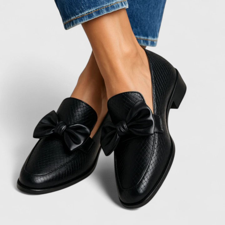 Black Vaenyss Luxe Comfort Loafers by THE WHITMORE FAMILY, featuring sleek leather design and comfortable slip-on style.