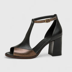 Black Kenzira modern heels by THE WHITMORE FAMILY, featuring sleek design and pointed toes on a white background.