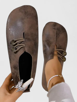 Black Kyline elegant loafers by THE WHITMORE FAMILY, showcasing sleek leather design and classic slip-on style.