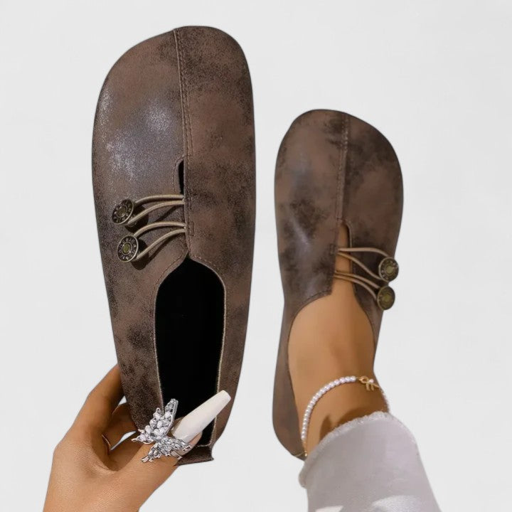 Black Kyline elegant loafers by THE WHITMORE FAMILY, showcasing sleek leather design and classic slip-on style.
