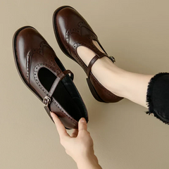 Black Patricia T-strap Mary Janes by THE WHITMORE FAMILY featuring a sleek, elegant design with a rounded toe and comfortable fit.