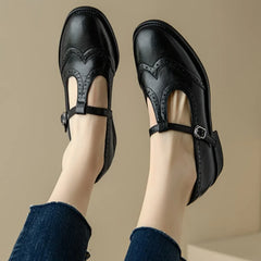Black Patricia T-strap Mary Janes by THE WHITMORE FAMILY featuring elegant design and classic leather straps.