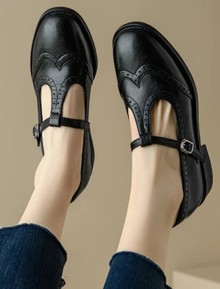 Black Patricia T-strap Mary Janes by THE WHITMORE FAMILY featuring elegant design and classic leather straps.