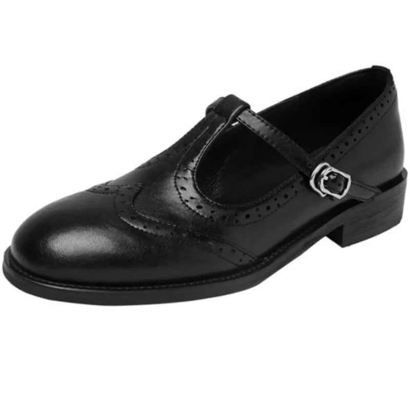 Black Patricia T-strap Mary Janes by THE WHITMORE FAMILY, featuring elegant design and classic leather detailing.