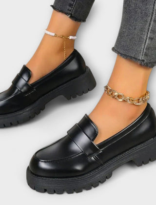 Black Pia orthopedic loafers by THE WHITMORE FAMILY, featuring a sleek design and comfortable fit for supportive casual wear.