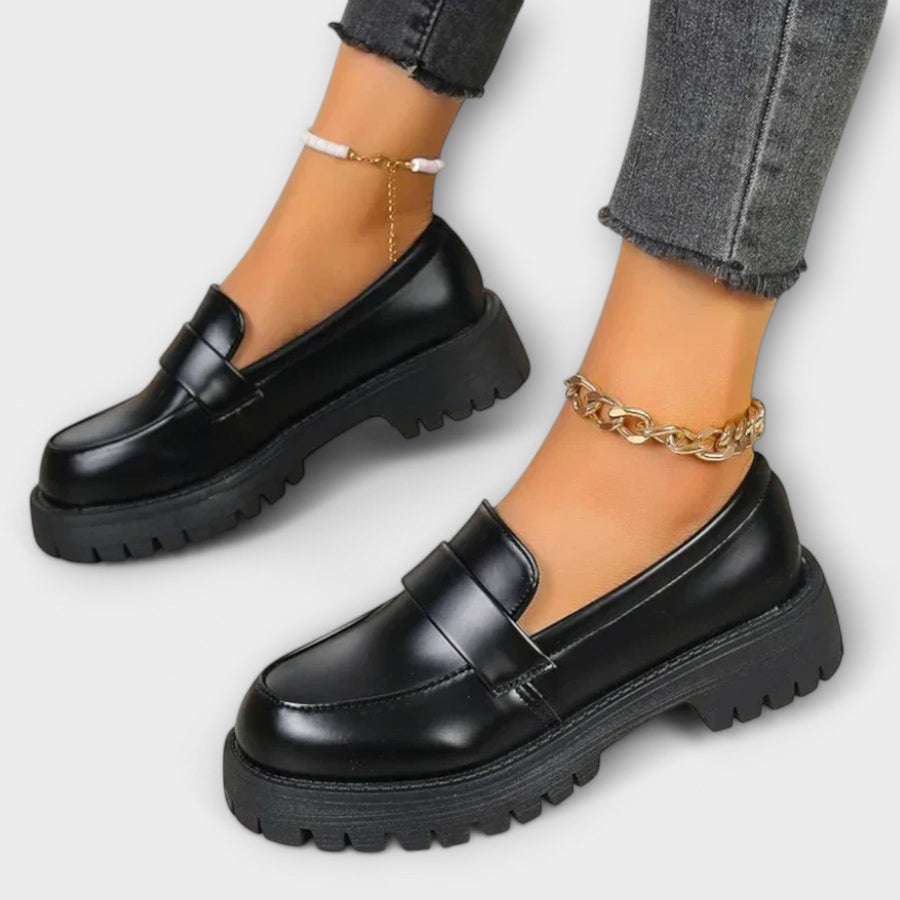 Black Pia orthopedic loafers by THE WHITMORE FAMILY, featuring a sleek design and comfortable fit for supportive casual wear.
