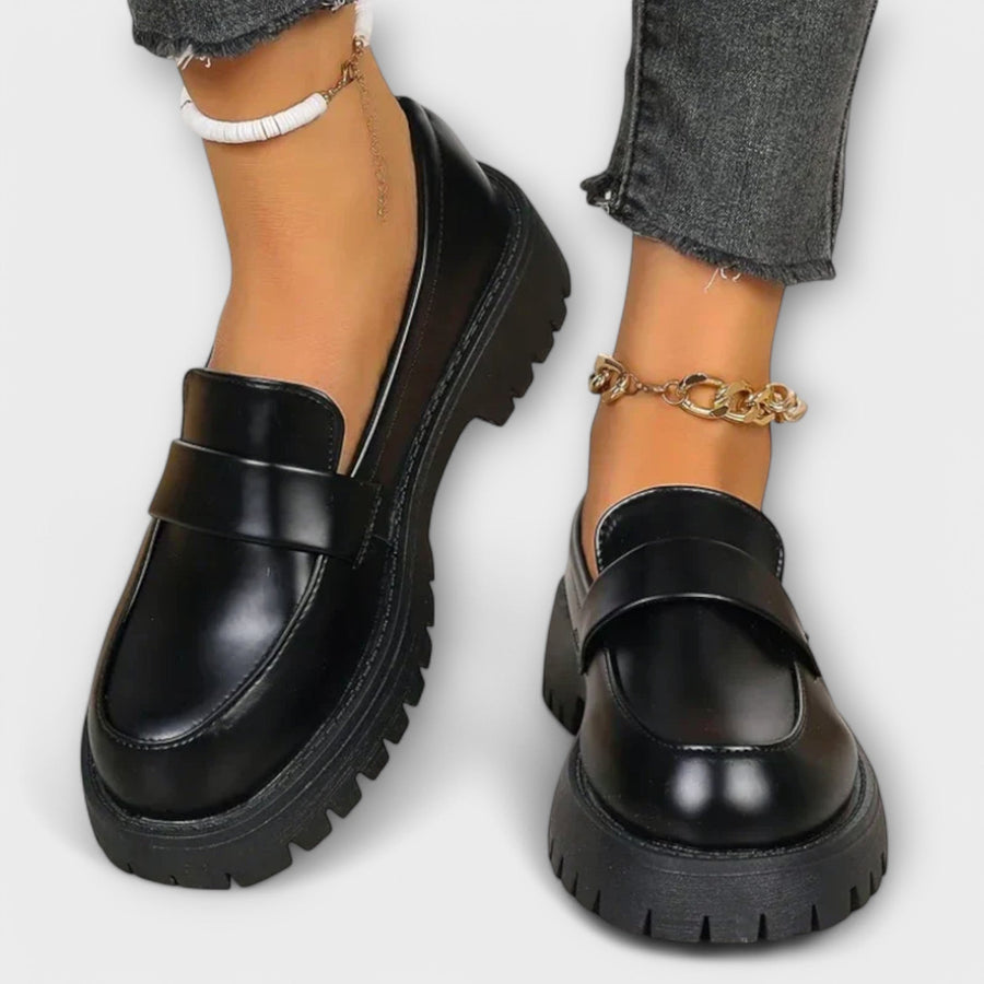 Black Pia orthopedic loafers by THE WHITMORE FAMILY featuring a sleek design and comfortable sole, ideal for everyday wear.