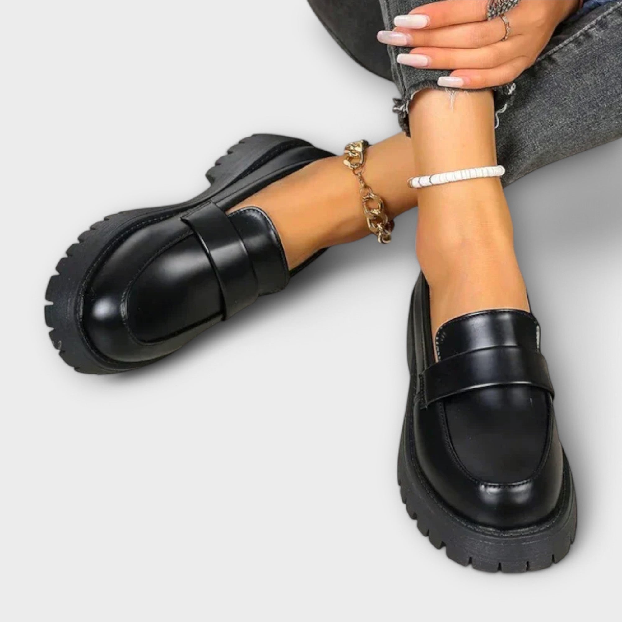 Black Pia orthopedic loafers by THE WHITMORE FAMILY featuring a sleek design and comfortable fit, displayed on a plain background.