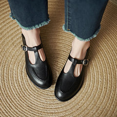 Black Selvana low-heeled pumps by THE WHITMORE FAMILY, featuring a sleek design and comfortable low heel.