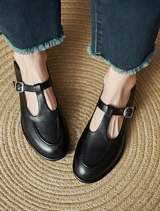 Black Selvana low-heeled pumps by THE WHITMORE FAMILY, featuring a sleek design and comfortable low heel.