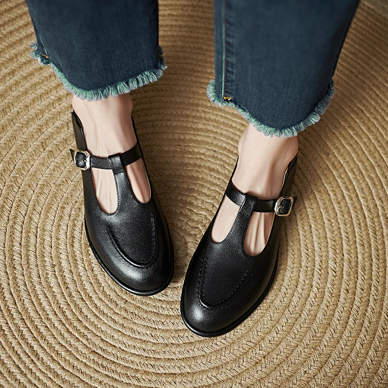 Black Selvana low-heeled pumps by THE WHITMORE FAMILY, featuring a sleek design and comfortable low heel.