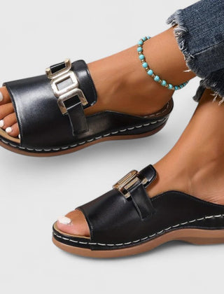 Black Sharpay™ sophisticated sandals by THE WHITMORE FAMILY with elegant straps and a sleek design for stylish comfort.