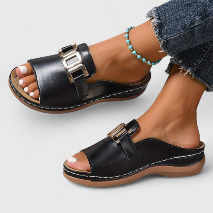 Black Sharpay™ sophisticated sandals by THE WHITMORE FAMILY with elegant straps and a sleek design for stylish comfort.