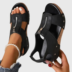 Black Styla™ orthopedic sandals by THE WHITMORE FAMILY featuring supportive straps and cushioned soles.