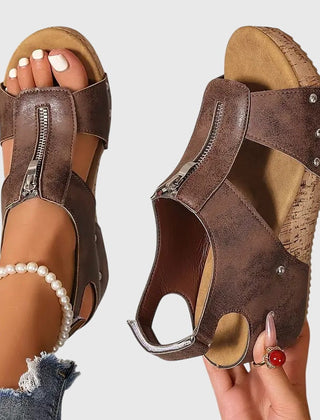 Black Styla™ orthopedic sandals by THE WHITMORE FAMILY, featuring supportive design and comfortable straps.