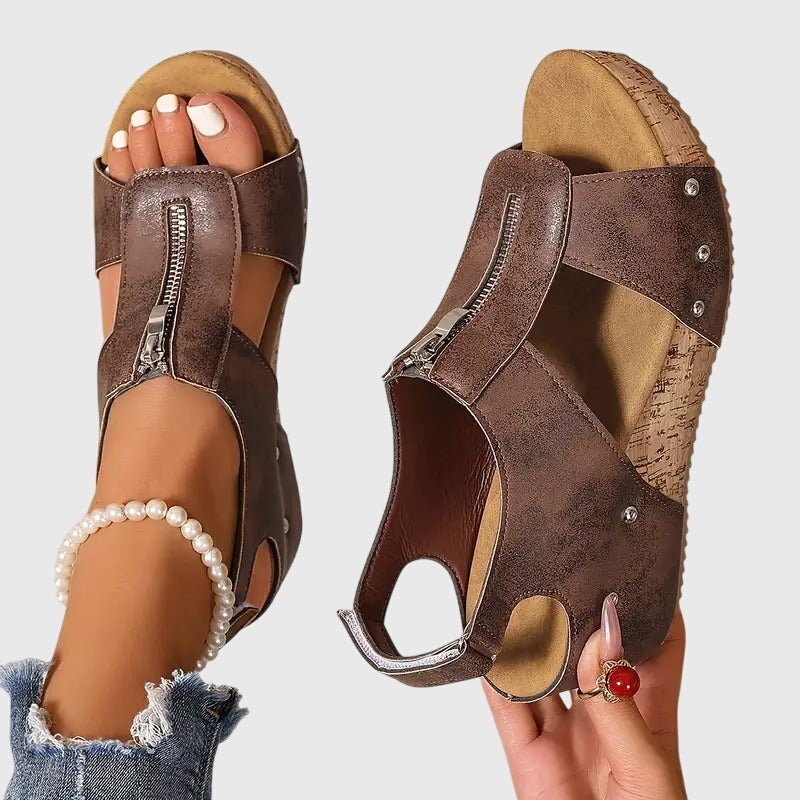 Black Styla™ orthopedic sandals by THE WHITMORE FAMILY, featuring supportive design and comfortable straps.