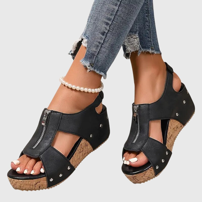 Black Styla™ orthopedic sandals by THE WHITMORE FAMILY with cushioned soles and adjustable straps for comfort and support.