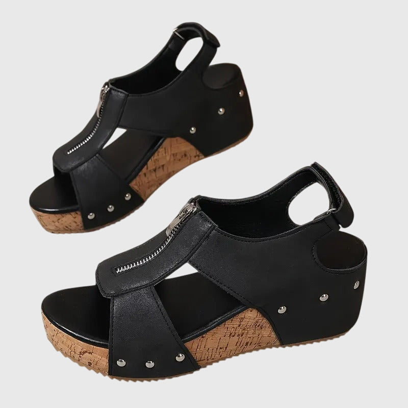 Black Styla™ orthopedic sandals by THE WHITMORE FAMILY with supportive straps and cushioned insoles for comfortable wear.